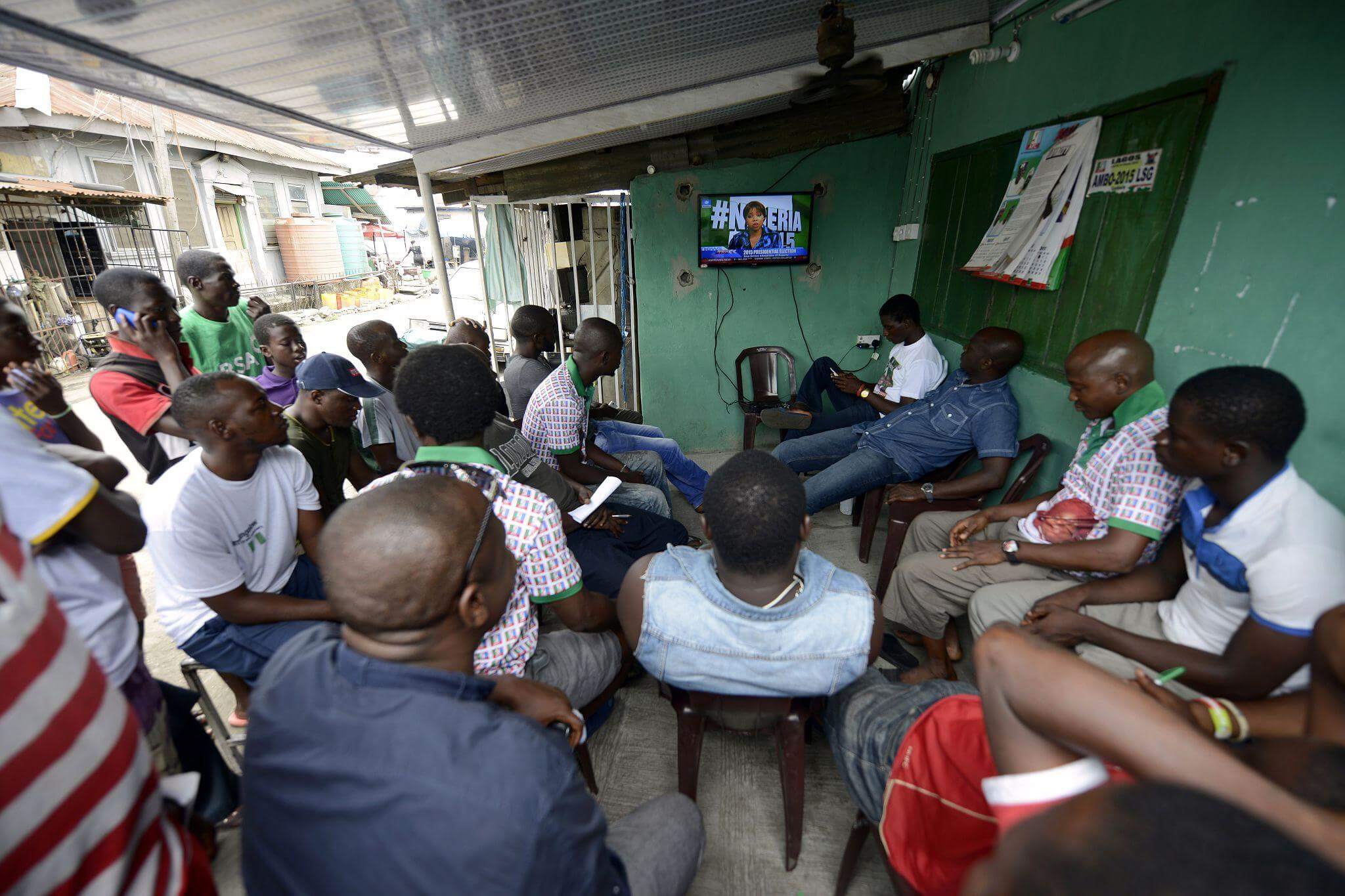 Nigerians gathered around a television, awaiting the official announcement of election results.