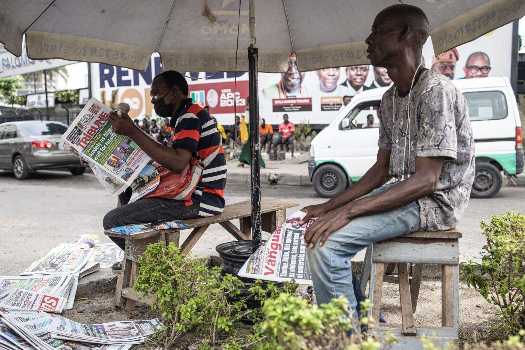 Nigerians at a newspaper stand, waiting for the announcement of an election result.