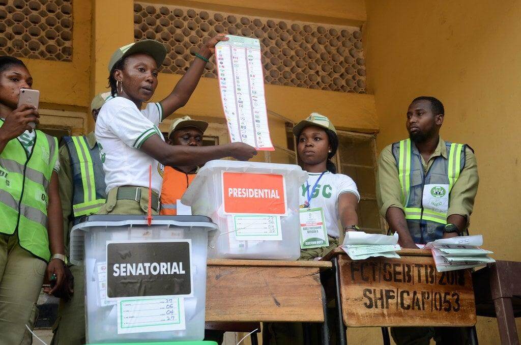 INEC Adhoc staff presenting ballots sheets during an election